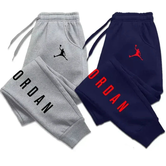 Man casual trousers sport jogging tracksuits pants in grey and navy, with drawstring waist and 'Jordan' logo, ideal for autumn and winter streetwear.