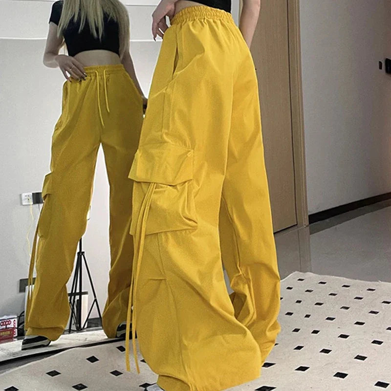 Y2K women's oversized yellow cargo pants with wide legs and big pockets.